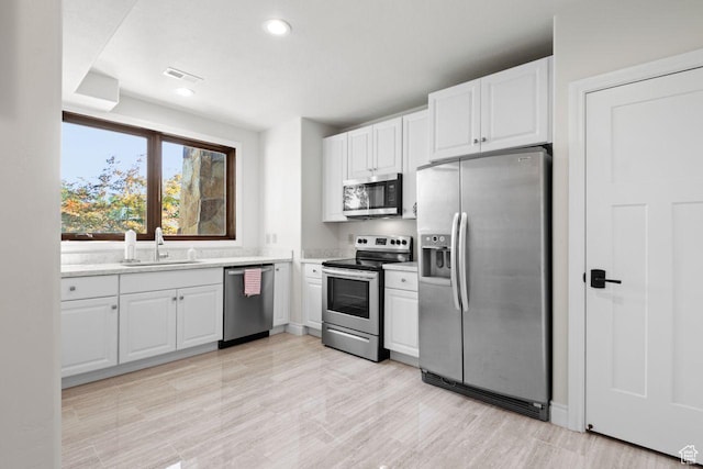10575 S Alexander Park Ln, South Jordan, UT 84095 - kitchen with recessed lighting, light countertops, white cabinetry, stainless steel appliances, and a sink