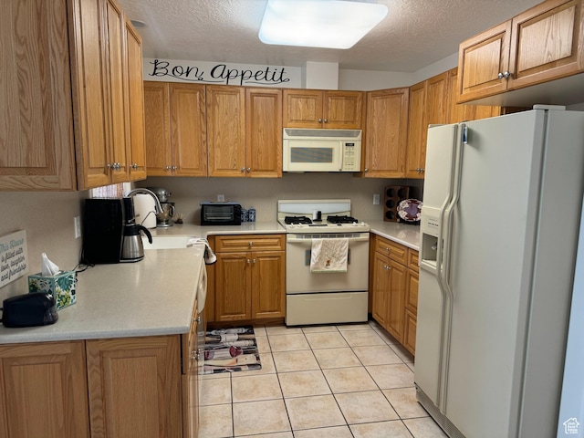 2480 W 450 S Unit 5, Springville, UT 84663 - kitchen with light countertops, white appliances, light tile patterned floors, a textured ceiling, and a sink