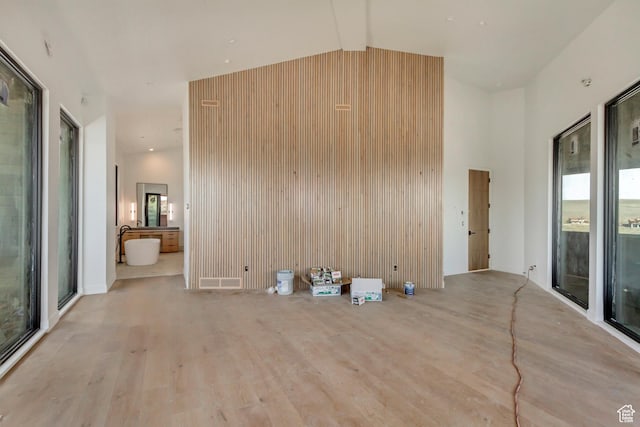 7165 Painted Valley Pass Unit 54, Park City, UT 84098 - unfurnished living room featuring high vaulted ceiling and wood finished floors