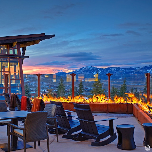 7165 Painted Valley Pass Unit 54, Park City, UT 84098 - patio terrace at dusk featuring an outdoor fire pit and a mountain view