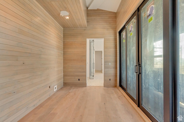 7165 Painted Valley Pass Unit 54, Park City, UT 84098 - spare room featuring lofted ceiling, wooden walls, a healthy amount of sunlight, and light wood-style flooring