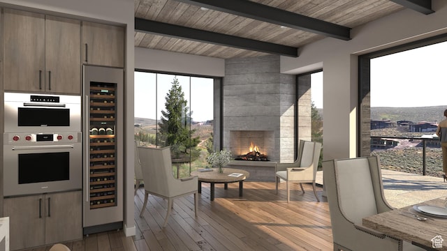 7165 Painted Valley Pass Unit 54, Park City, UT 84098 - kitchen featuring hardwood / wood-style flooring, beverage cooler, stainless steel double oven, wood ceiling, and beamed ceiling