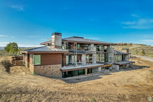 7165 Painted Valley Pass Unit 54, Park City, UT 84098 - rear view of house with a chimney, stone siding, and metal roof