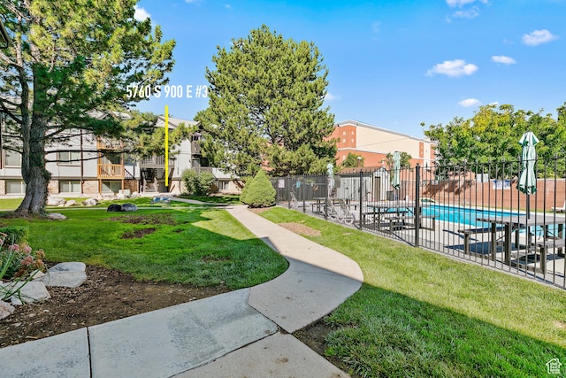 5760 S 900 E Unit 3, Murray, UT 84121 - view of property's community featuring a lawn, fence, and a swimming pool
