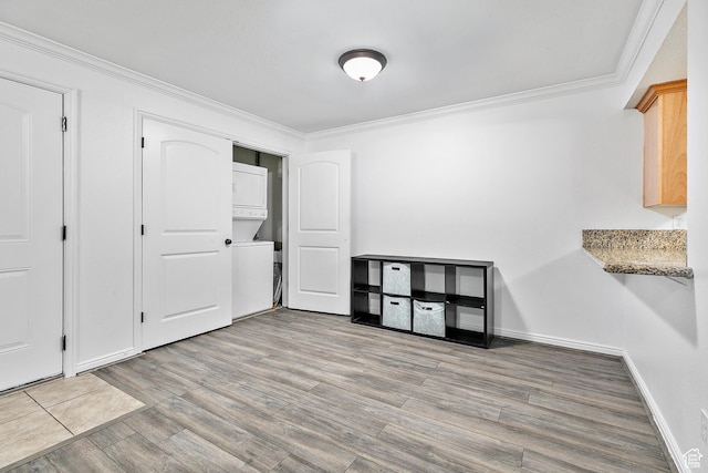 5760 S 900 E Unit 3, Murray, UT 84121 - unfurnished dining area with baseboards, wood finished floors, stacked washer / dryer, and ornamental molding
