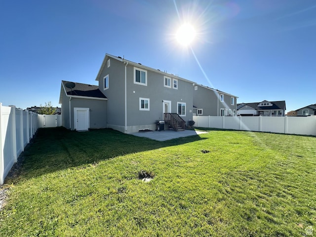 2142 W 3100 S, West Haven, UT 84401 - back of house featuring a fenced backyard, stucco siding, and a lawn