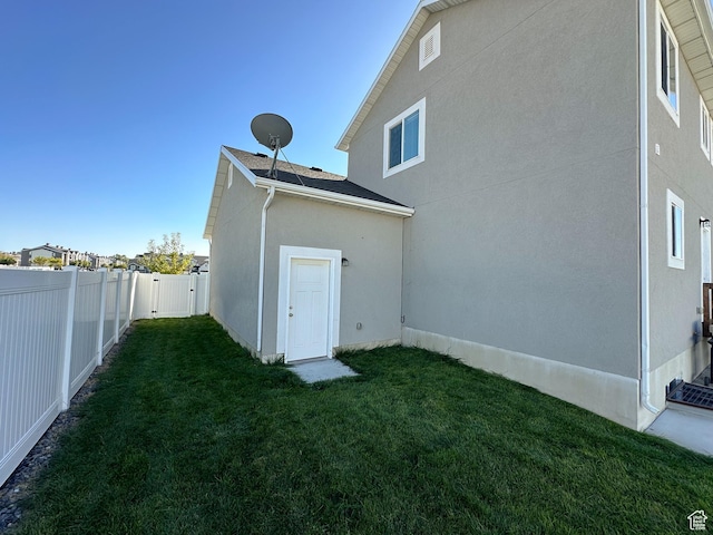 2142 W 3100 S, West Haven, UT 84401 - back of property with stucco siding, a fenced backyard, and a yard