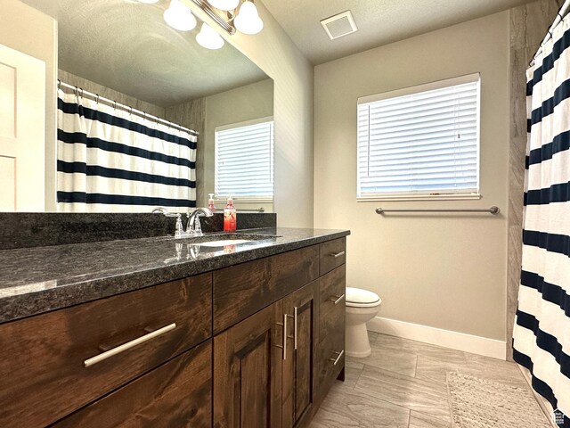 2142 W 3100 S, West Haven, UT 84401 - full bath with a textured ceiling, visible vents, baseboards, toilet, and vanity