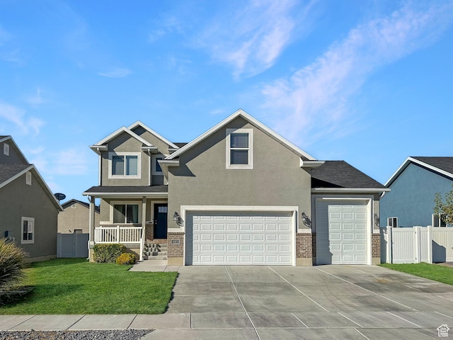 2142 W 3100 S, West Haven, UT 84401 - view of front of house with stucco siding, fence, driveway, a front lawn, and covered porch