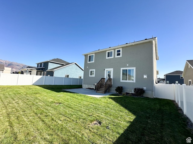 2142 W 3100 S, West Haven, UT 84401 - rear view of property featuring a fenced backyard, stucco siding, a patio, and a yard