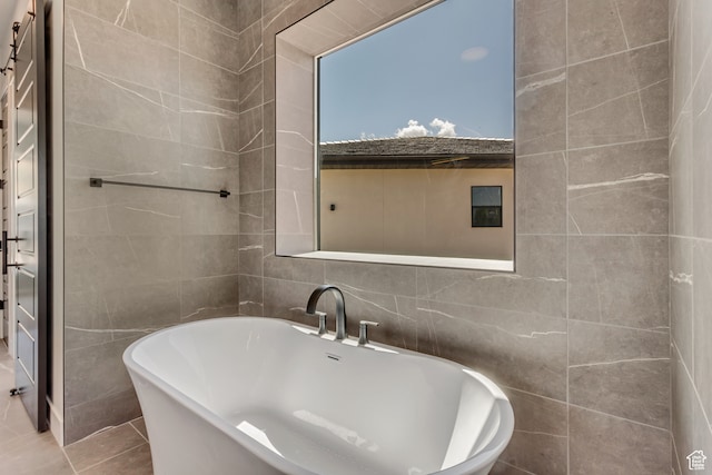 713 E 1500 N Unit 19, Orem, UT 84097 - bathroom with a bathtub, tile walls, and tile patterned floors