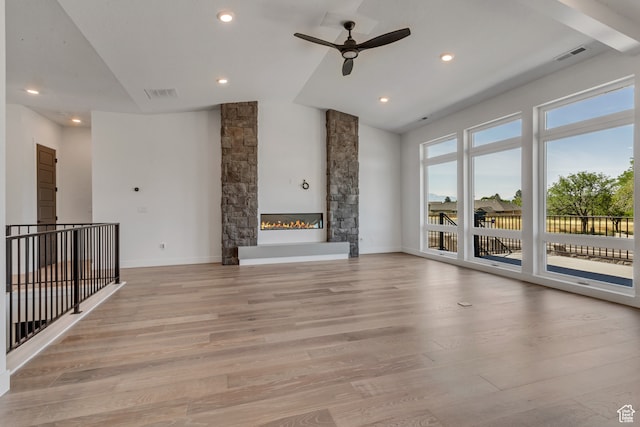 713 E 1500 N Unit 19, Orem, UT 84097 - unfurnished living room featuring ceiling fan, a stone fireplace, and light hardwood / wood-style floors