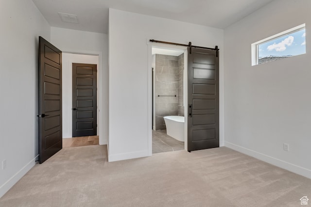 713 E 1500 N Unit 19, Orem, UT 84097 - unfurnished bedroom featuring light colored carpet, ensuite bath, and a barn door