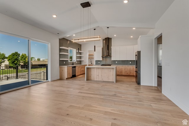 713 E 1500 N Unit 19, Orem, UT 84097 - kitchen with hanging light fixtures, wall chimney range hood, white cabinetry, stainless steel appliances, and a center island