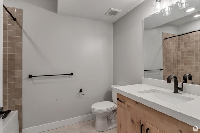 bathroom featuring toilet, vanity, visible vents, tile patterned floors, and baseboards