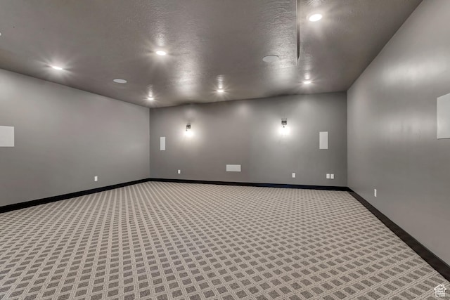 carpeted spare room featuring baseboards and recessed lighting