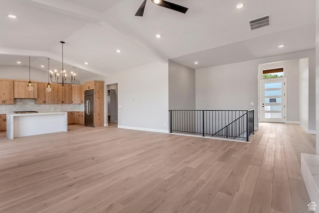 unfurnished living room featuring light wood-style flooring, ceiling fan with notable chandelier, baseboards, and vaulted ceiling with beams