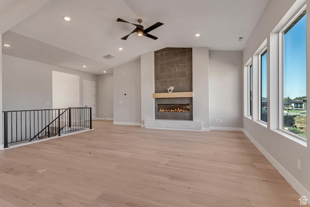 unfurnished living room with visible vents, ceiling fan, light wood-style floors, lofted ceiling, and recessed lighting