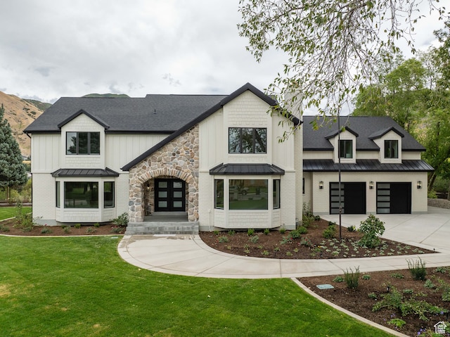 view of front of home with a front lawn and a garage