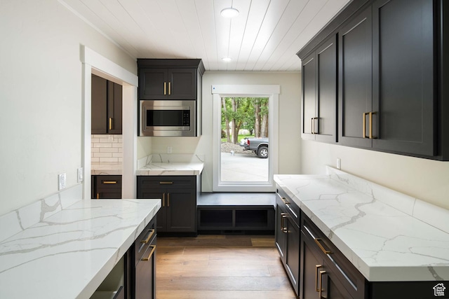 715 E 1700 N, Mapleton, UT 84664 - kitchen featuring stainless steel microwave, light stone counters, light wood finished floors, and recessed lighting