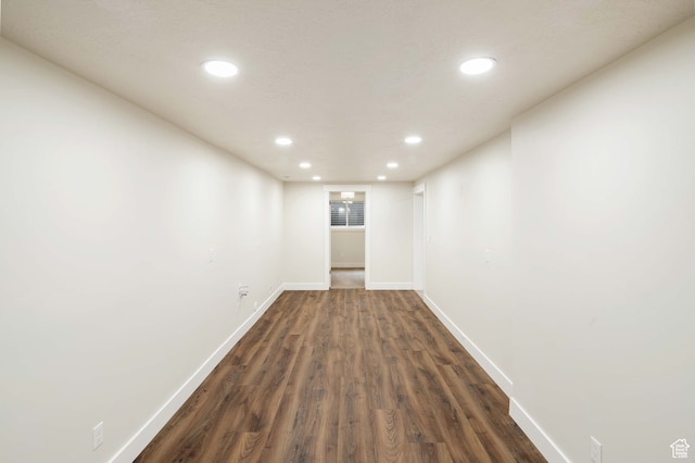 unfurnished room with dark hardwood / wood-style flooring