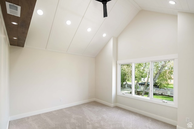 carpeted spare room featuring vaulted ceiling