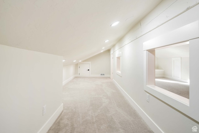 bonus room featuring light carpet and lofted ceiling