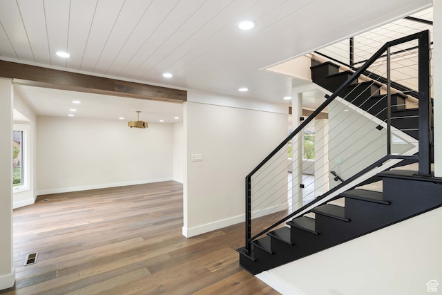 stairway with hardwood / wood-style floors