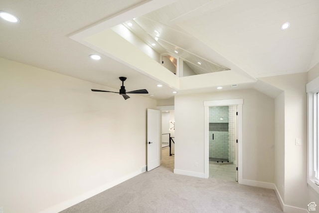unfurnished bedroom with ceiling fan, lofted ceiling, and light carpet
