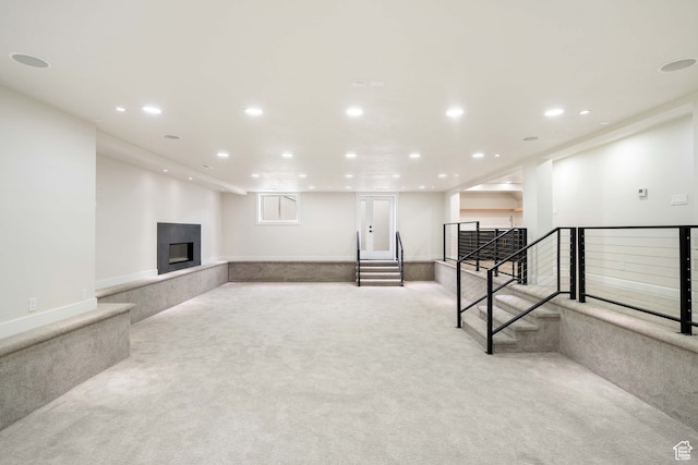 interior space with light colored carpet and a multi sided fireplace