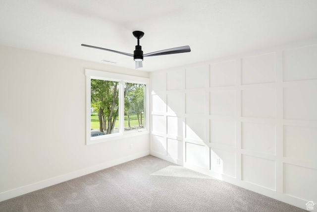 carpeted spare room featuring ceiling fan
