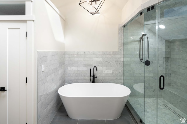 bathroom with independent shower and bath, tile walls, and tile patterned floors
