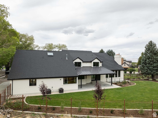 715 E 1700 N, Mapleton, UT 84664 - rear view of property featuring a patio area, a standing seam roof, roof with shingles, central AC unit, and brick siding