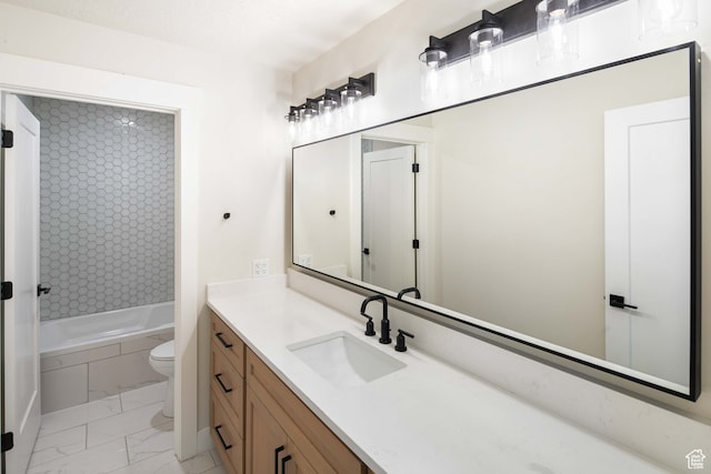 full bathroom with vanity, tiled shower / bath combo, and toilet