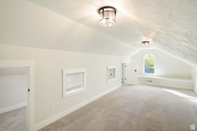 715 E 1700 N, Mapleton, UT 84664 - additional living space with a textured ceiling, light carpet, lofted ceiling, and baseboards