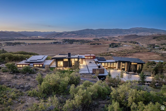 27 Normans Way, Park City, UT 84060 - back of property at dusk featuring a mountain view and solar panels