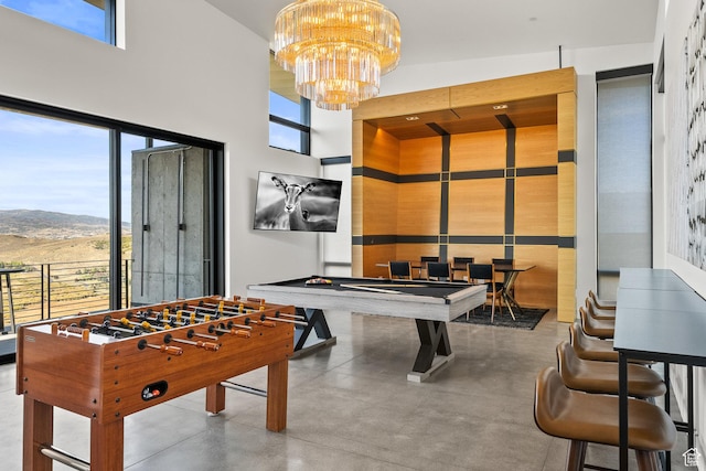 27 Normans Way, Park City, UT 84060 - game room with finished concrete floors, a high ceiling, a chandelier, billiards table, and a mountain view