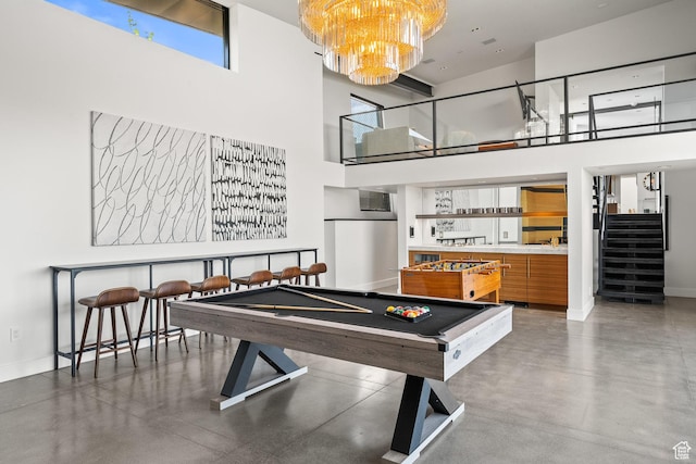 27 Normans Way, Park City, UT 84060 - rec room with a high ceiling, a chandelier, baseboards, billiards table, and concrete flooring
