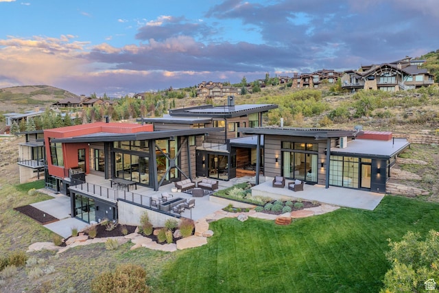 27 Normans Way, Park City, UT 84060 - back of house at dusk with a patio area, a yard, and an outdoor hangout area