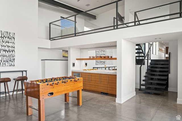 27 Normans Way, Park City, UT 84060 - game room with concrete floors, baseboards, a towering ceiling, and wet bar
