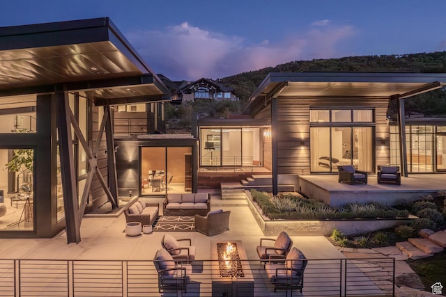 27 Normans Way, Park City, UT 84060 - back of property at dusk with an outdoor living space with a fire pit and a patio