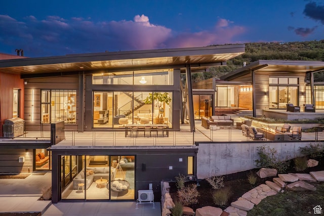 27 Normans Way, Park City, UT 84060 - back of house at dusk with an outdoor hangout area and a patio