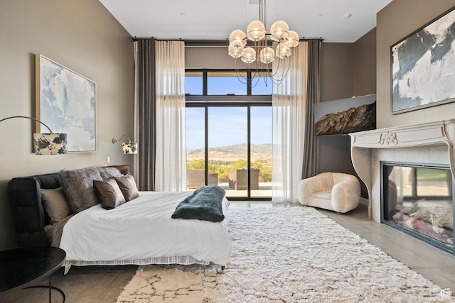 27 Normans Way, Park City, UT 84060 - bedroom with a chandelier, multiple windows, a glass covered fireplace, and access to exterior
