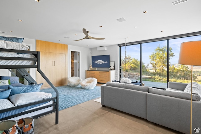 27 Normans Way, Park City, UT 84060 - living room featuring finished concrete flooring, plenty of natural light, ceiling fan, a wall of windows, and a wall mounted air conditioner