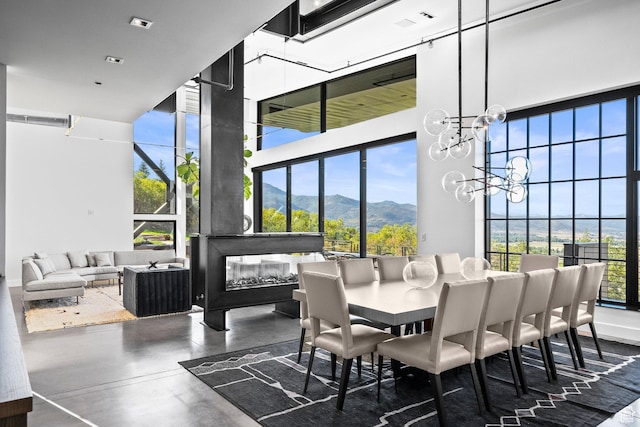 27 Normans Way, Park City, UT 84060 - dining area with a mountain view, a towering ceiling, concrete flooring, and a chandelier