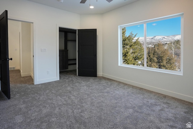 9542 Ridge Pine Rd, Heber City, UT 84032 - unfurnished bedroom featuring ceiling fan, a mountain view, and dark colored carpet