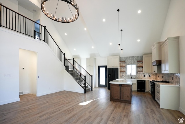 9542 Ridge Pine Rd, Heber City, UT 84032 - kitchen with decorative light fixtures, dark wood-type flooring, black appliances, and a kitchen island
