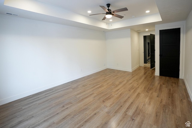 9542 Ridge Pine Rd, Heber City, UT 84032 - unfurnished room featuring a raised ceiling, ceiling fan, and light hardwood / wood-style floors