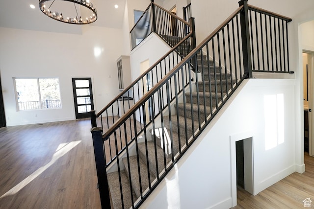 9542 Ridge Pine Rd, Heber City, UT 84032 - staircase featuring an inviting chandelier, wood-type flooring, and a high ceiling