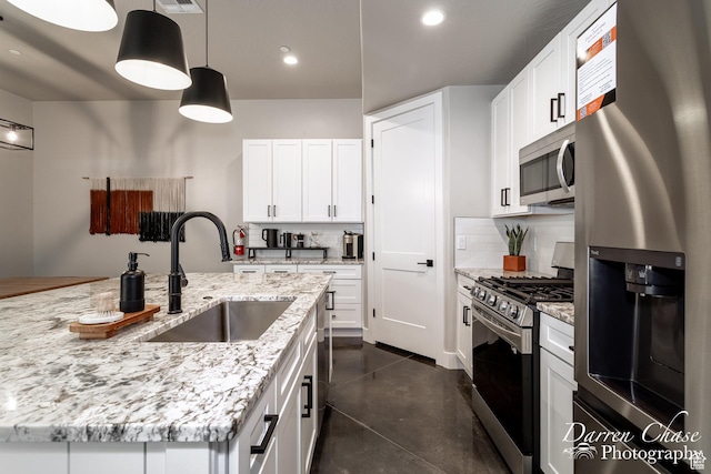 1460 S Windsor Pkwy Unit 5, Hurricane, UT 84737 - kitchen featuring a sink, stainless steel appliances, backsplash, white cabinetry, and pendant lighting